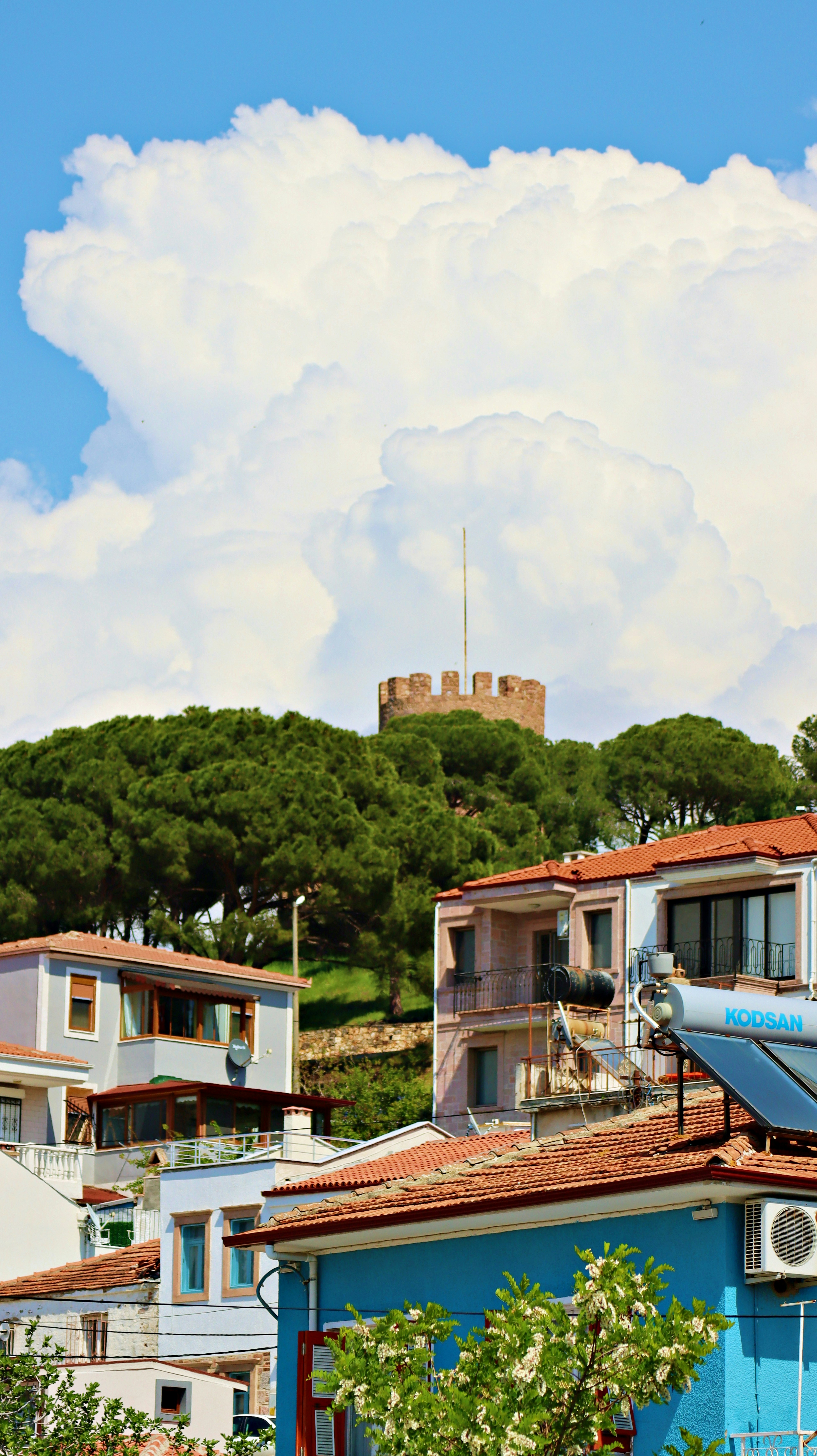 a blue building with a clock tower in the background