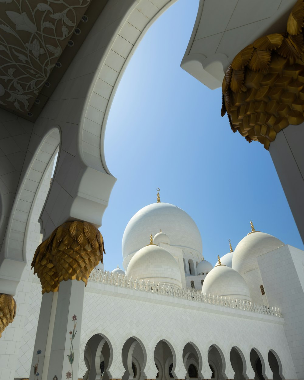 a large white building with arches and domes