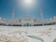Wide shot of the sprawling courtyard of the Masjid e Nabvi bathed in golden sunlight.