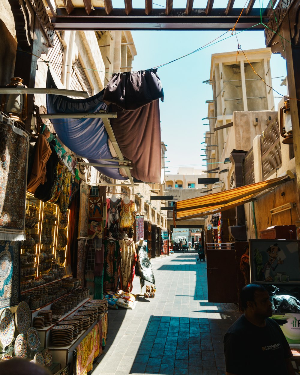 a narrow street with a few shops on both sides