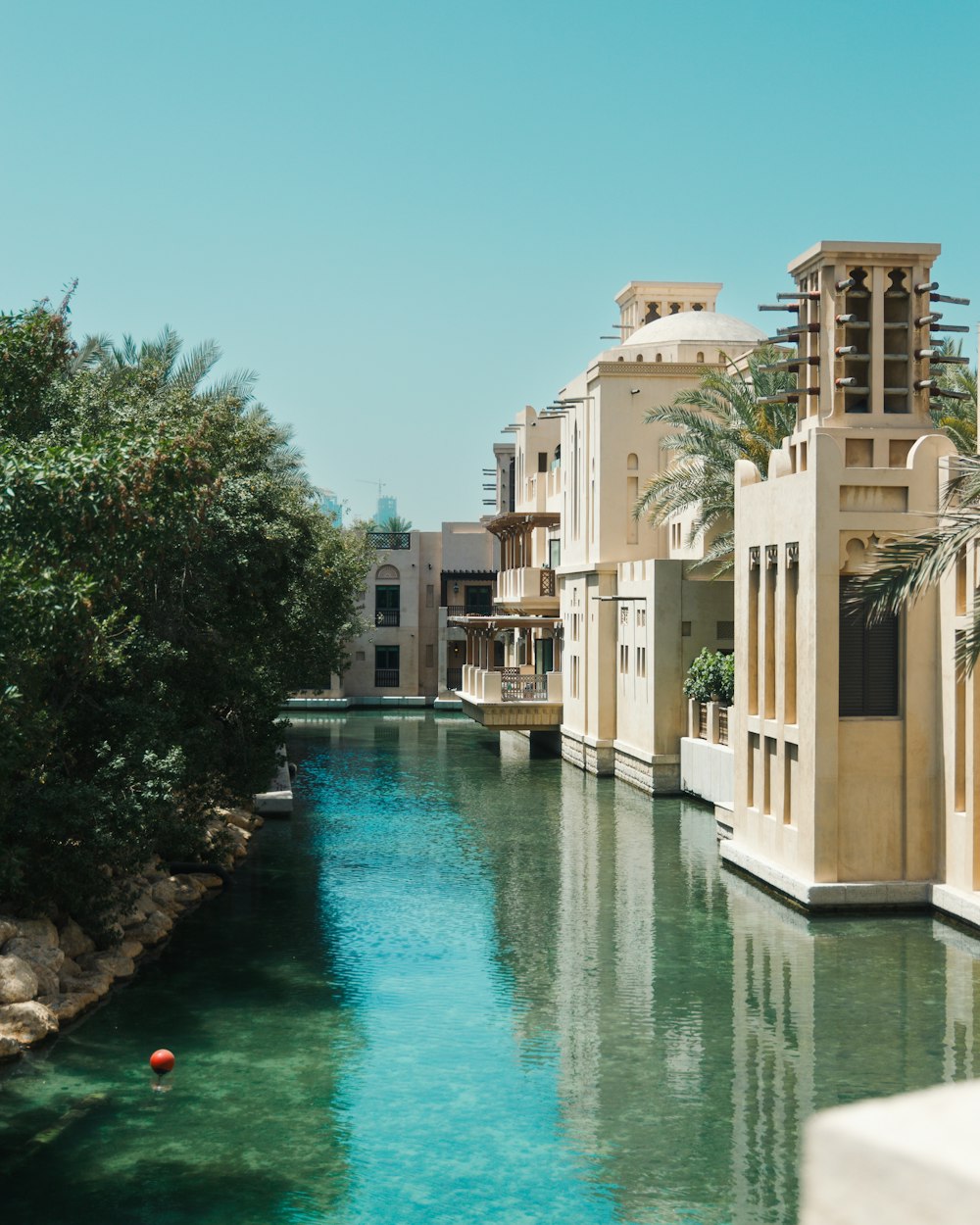 a river running through a city next to tall buildings