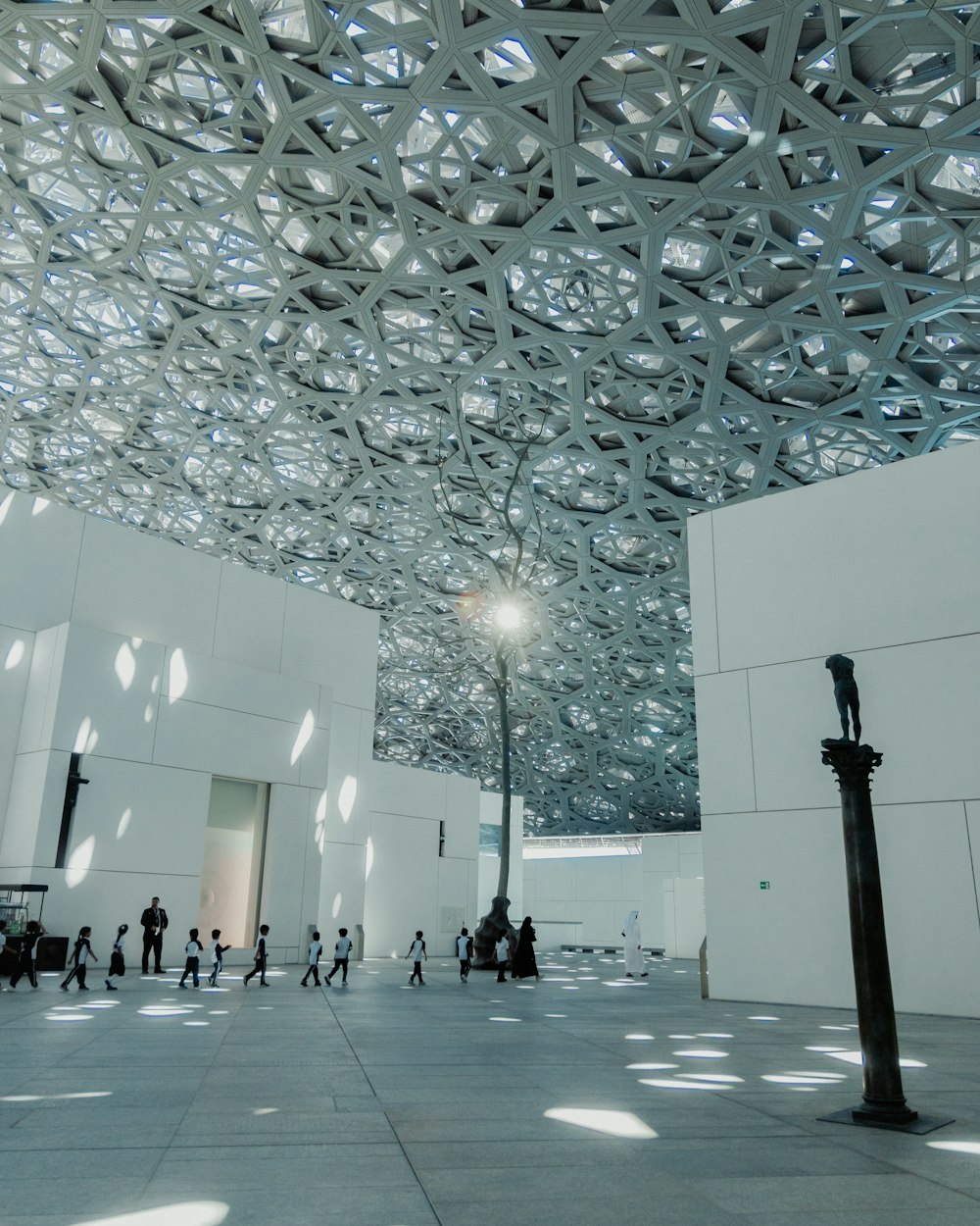 a group of people walking inside of a building