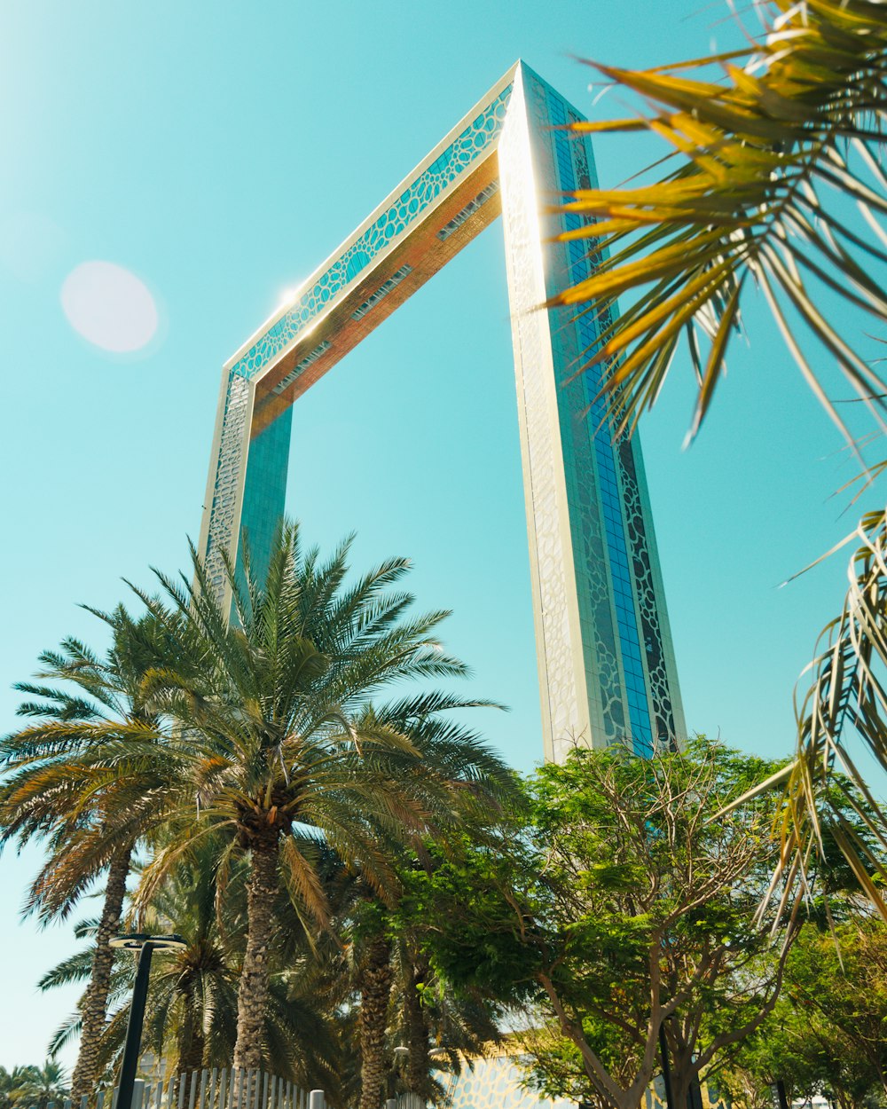 a palm tree in front of a tall building