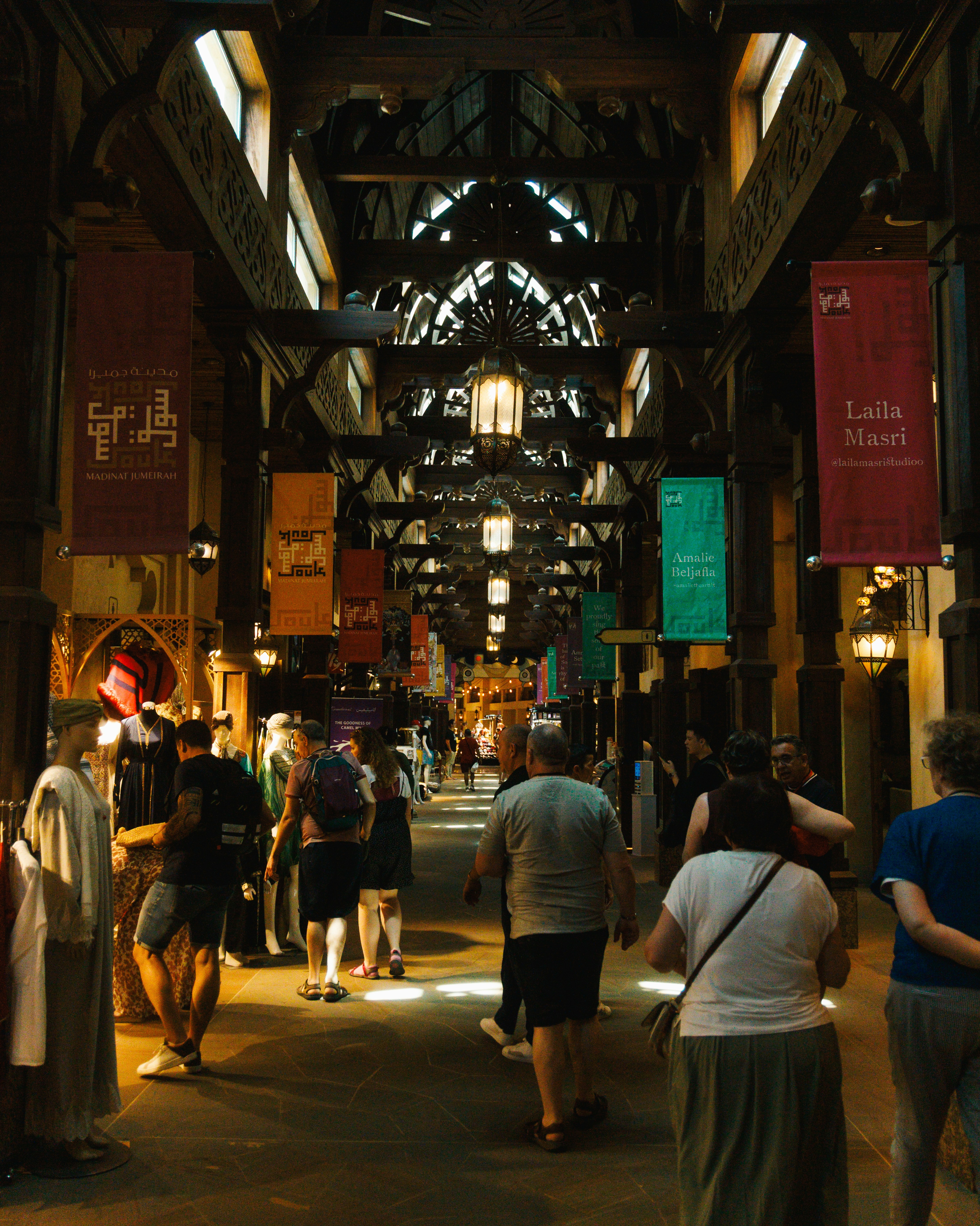 A group of people walking through a large building