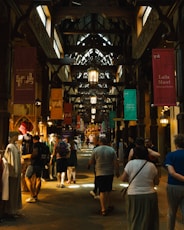 a group of people walking through a large building