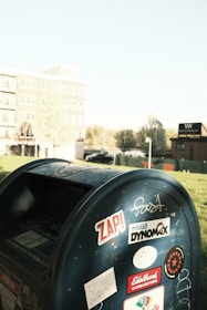 A USPS mailbox with a clear blue sky in the background at the front of the store.