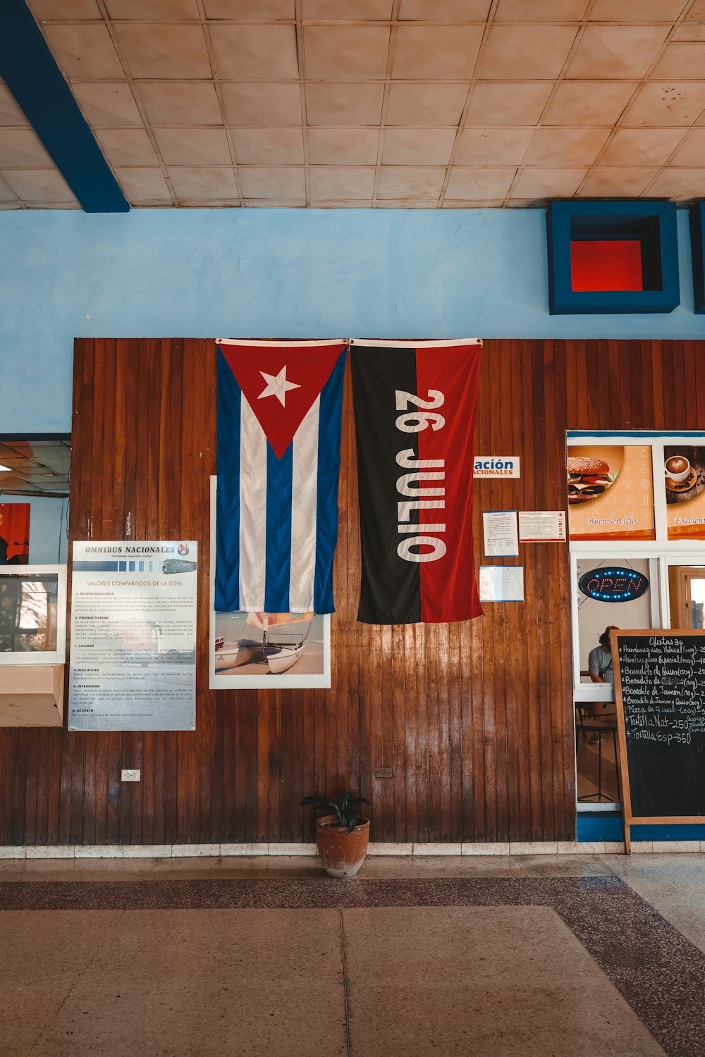 a restaurant with flags hanging on the wall