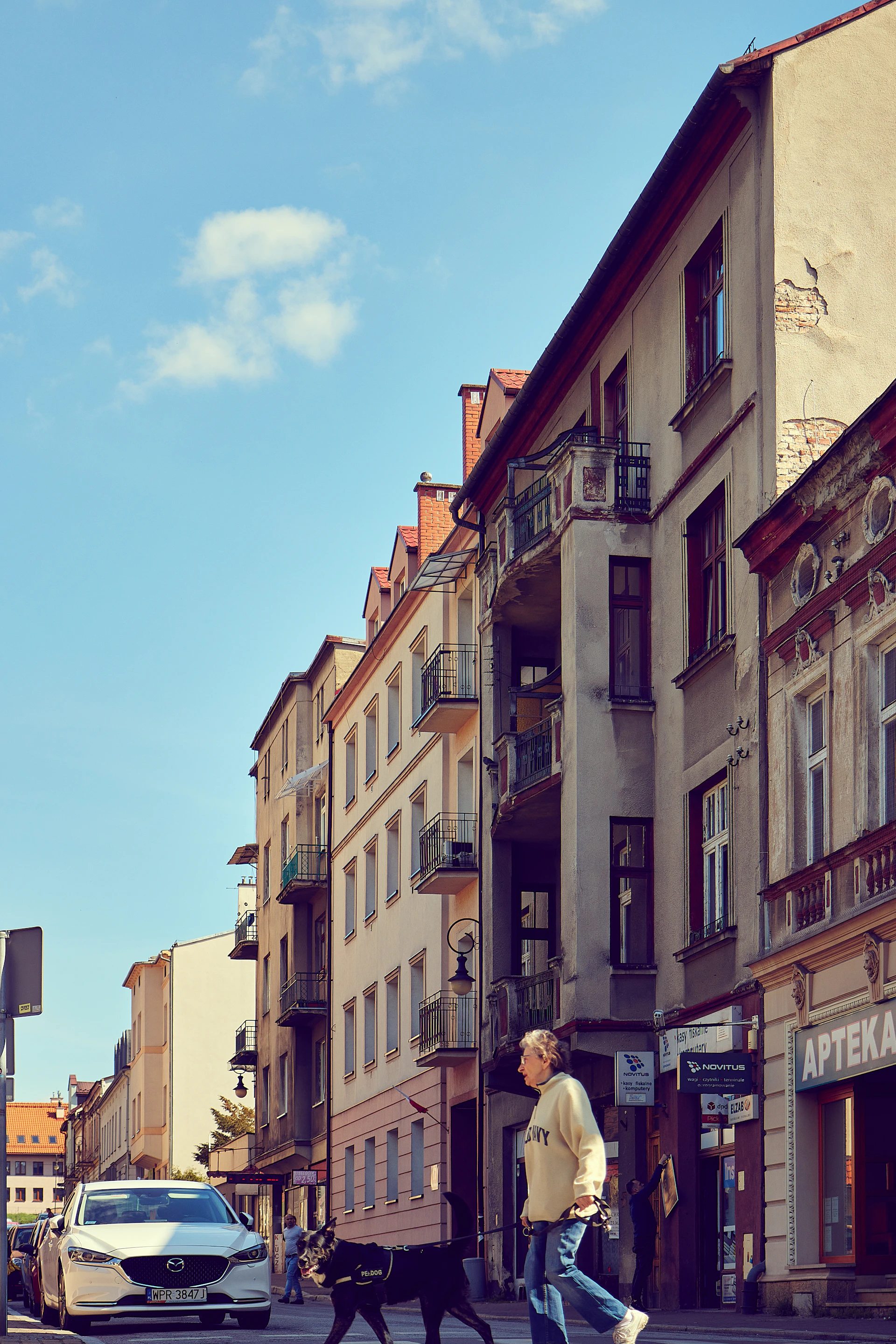 woman wearing yellow long-sleeved dress under white clouds and blue sky during daytime
