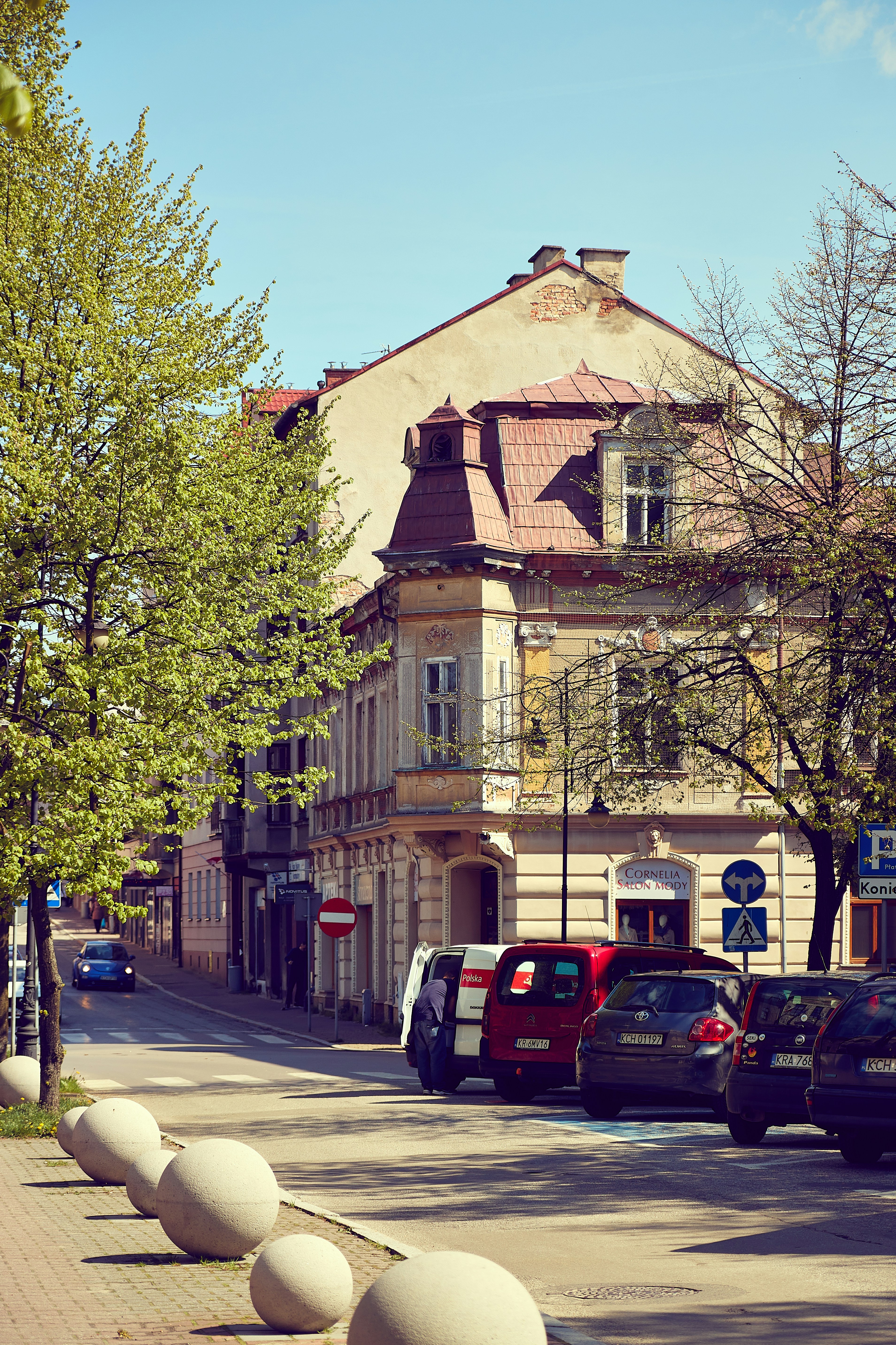 cars parked on the side of the road in front of a building