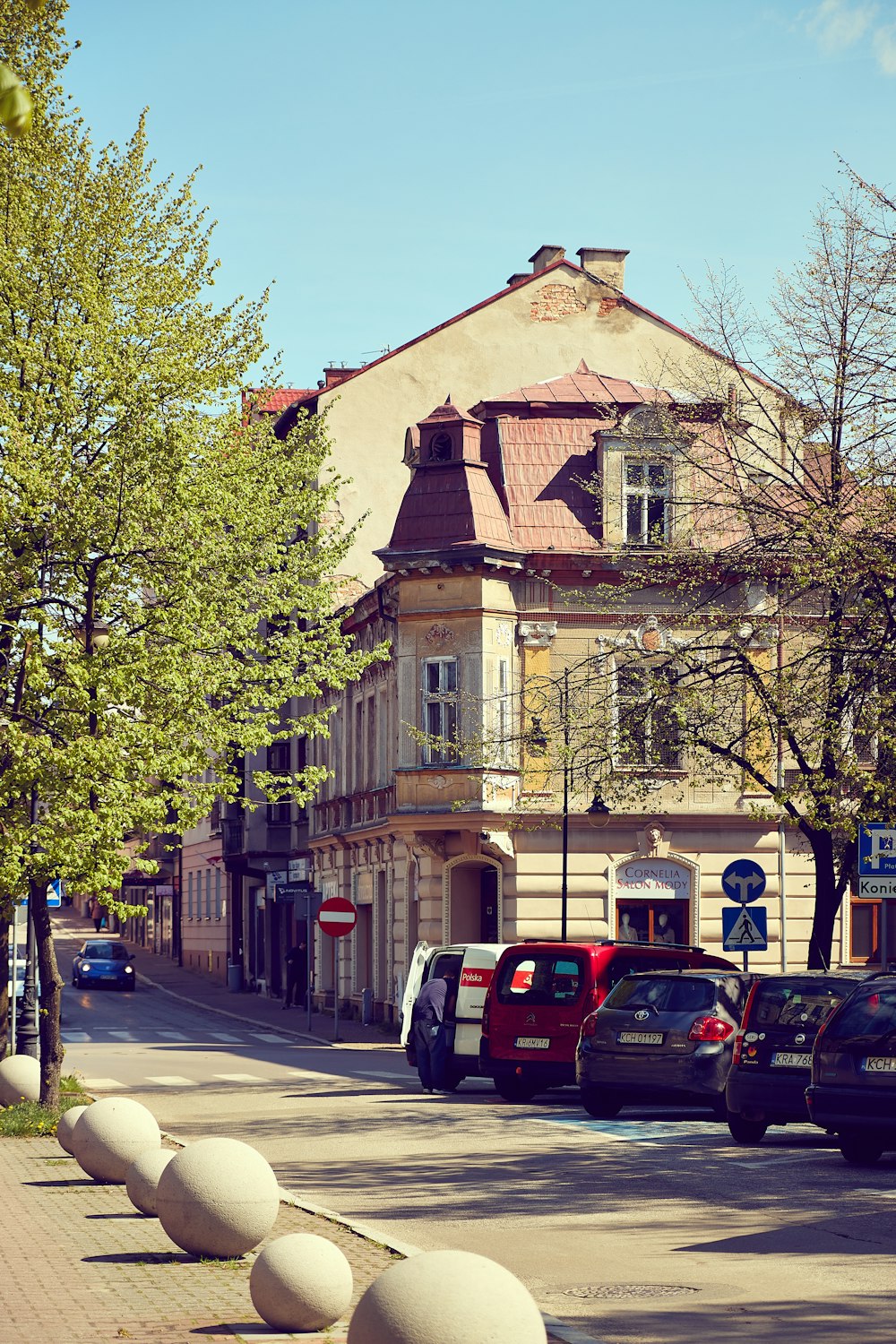 cars parked on the side of the road in front of a building