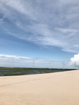 A serene landscape with wind turbines and solar panels representing sustainable energy efforts.
