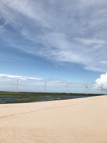 A serene landscape showcasing solar panels and wind turbines.
