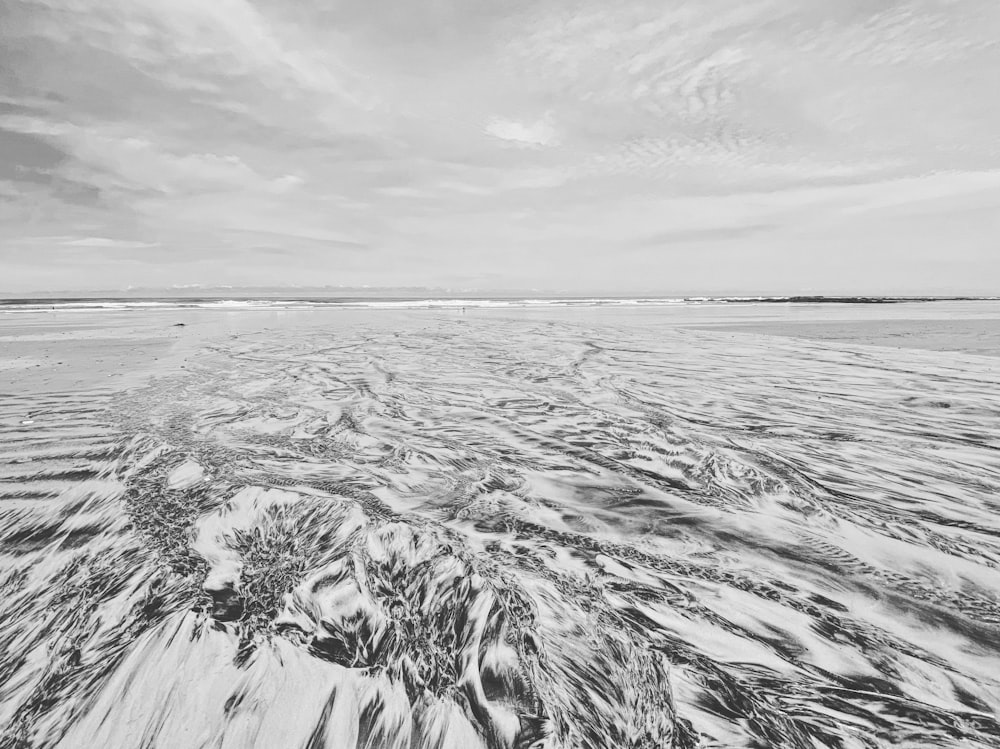 a black and white photo of a beach