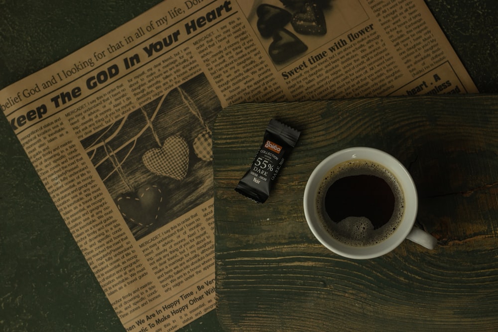 a cup of coffee sitting on top of a wooden table