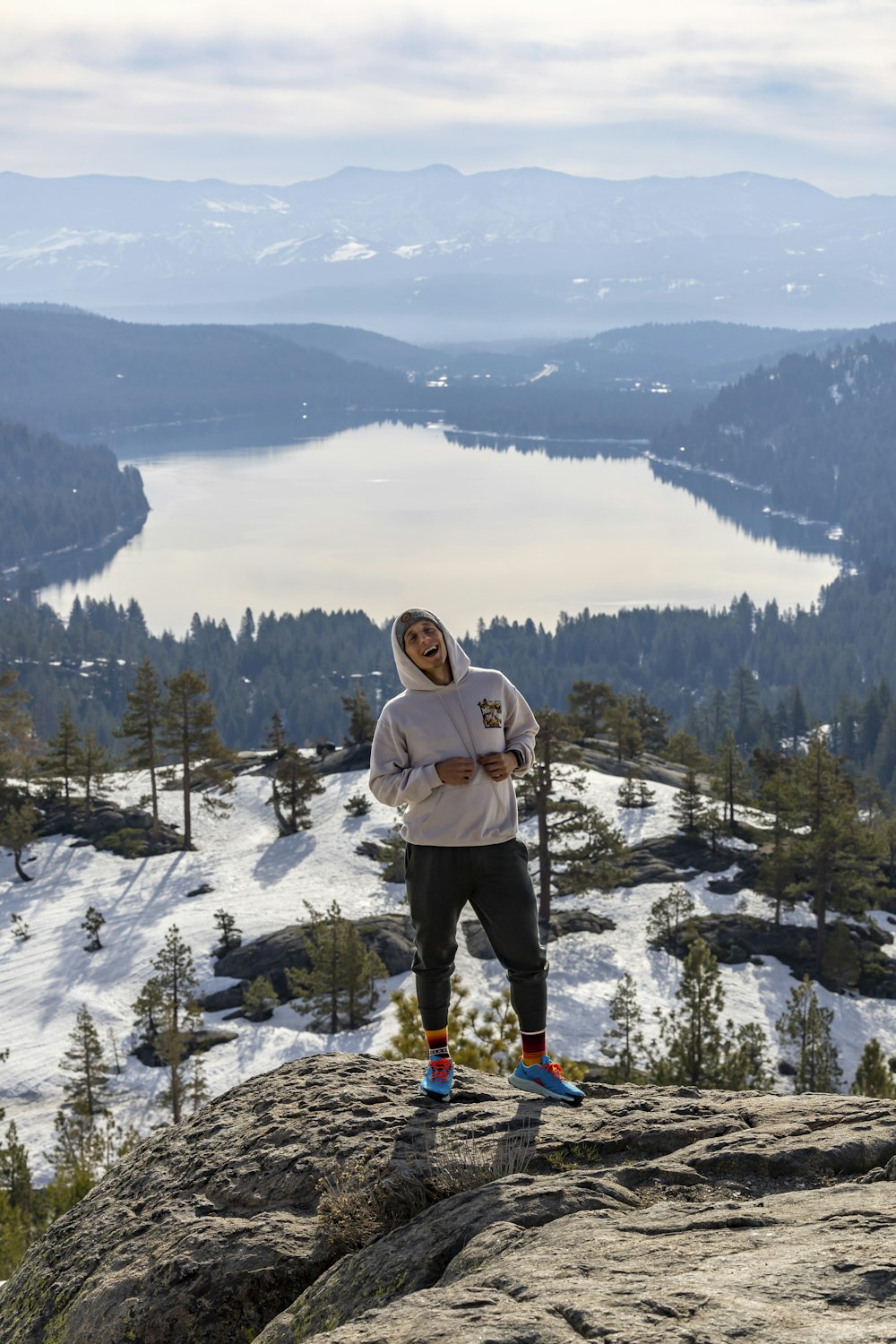 a man standing on top of a snow covered mountain