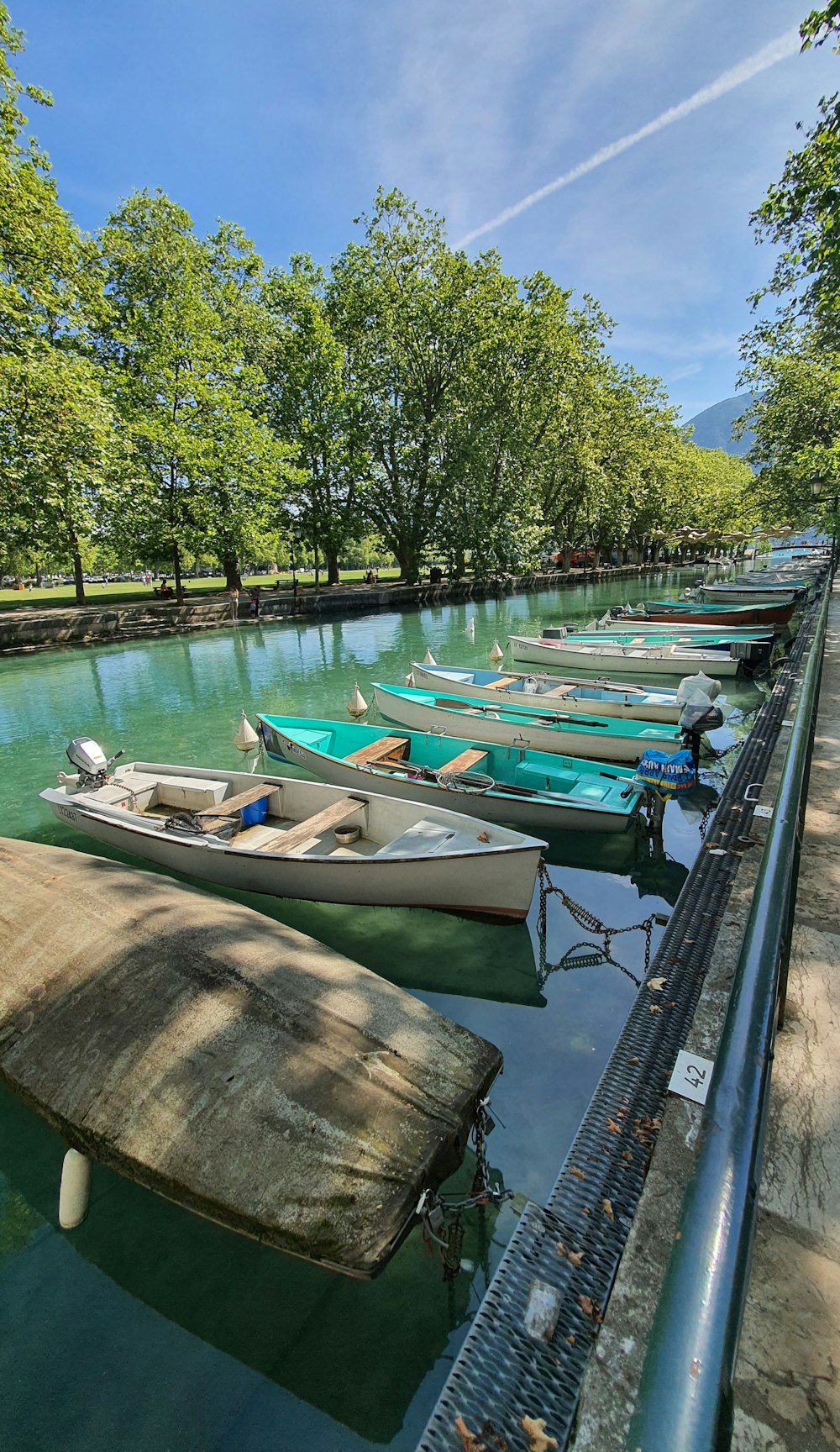 a row of boats sitting on top of a river