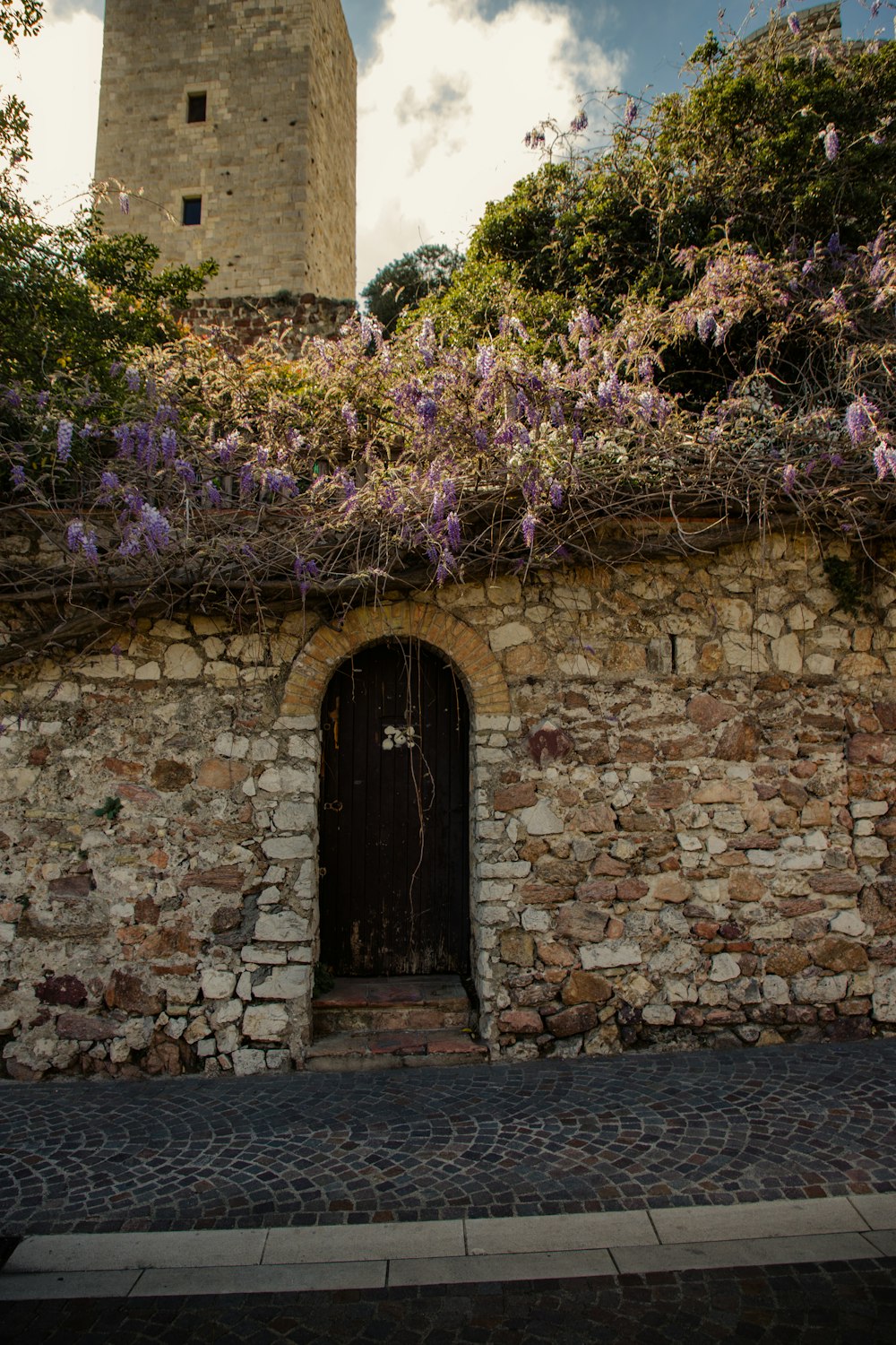 a stone building with a clock tower in the background