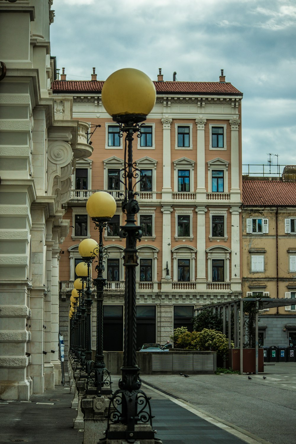 a street light sitting next to a tall building