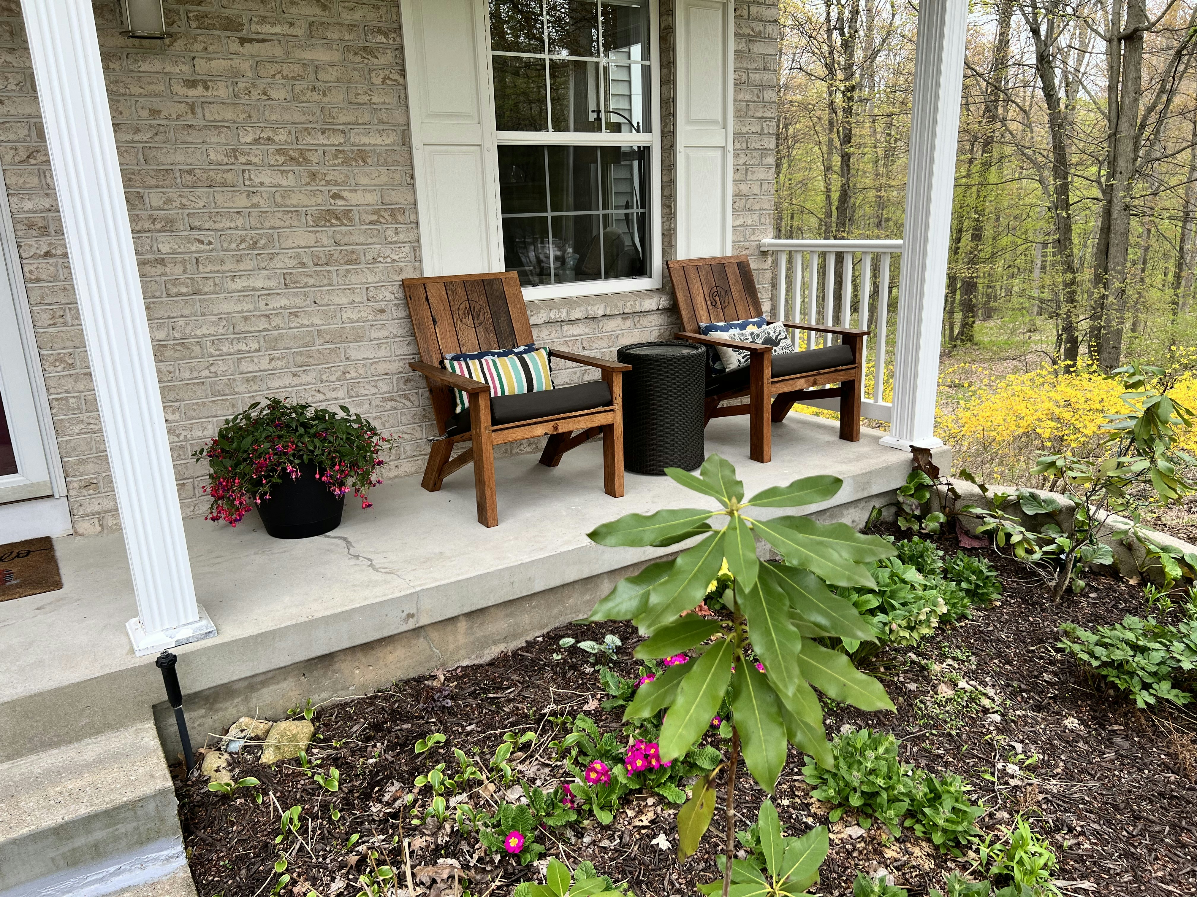 a couple of chairs sitting on top of a porch