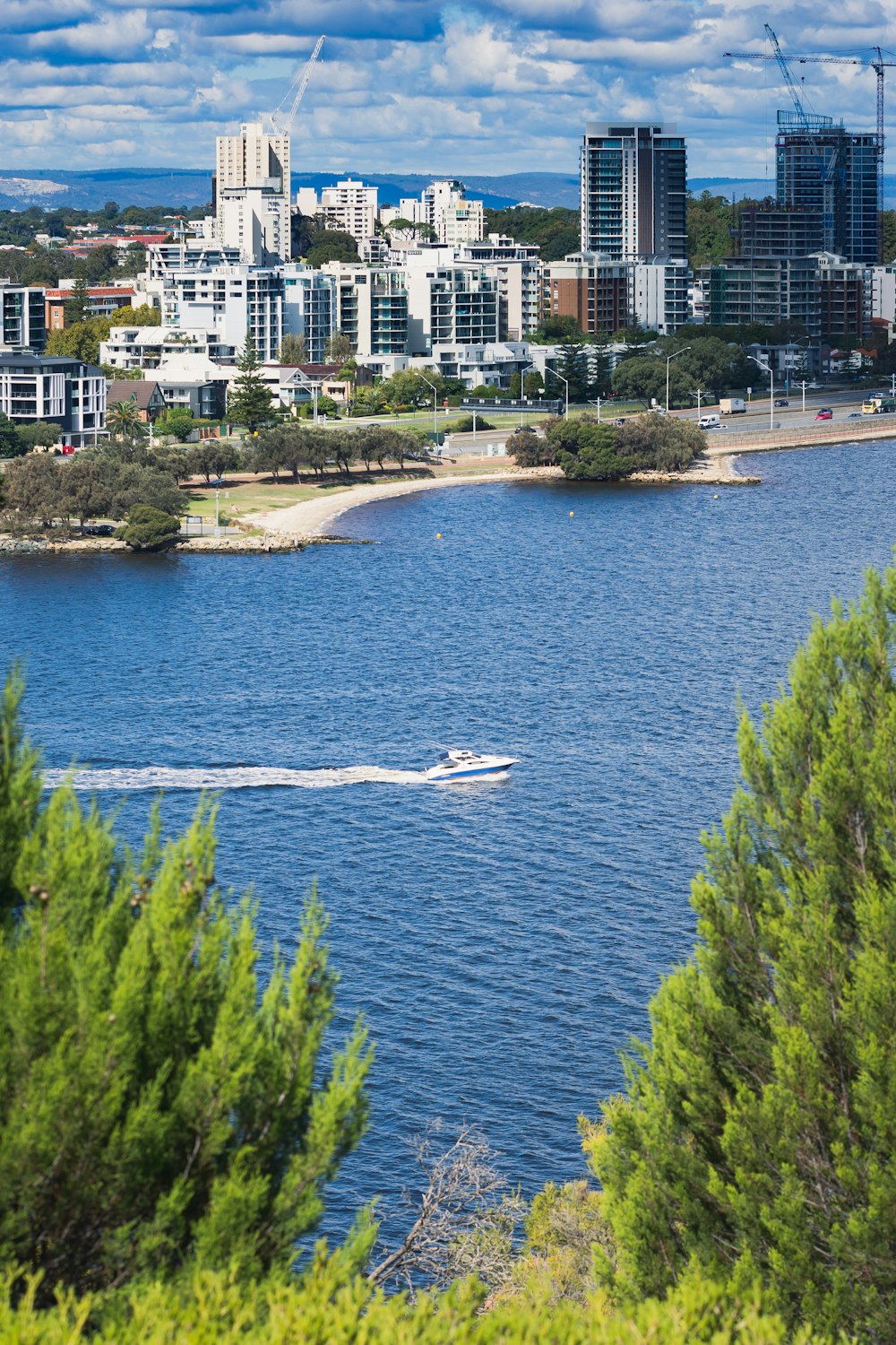 a boat is in the water near a city