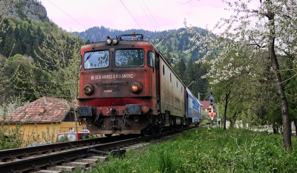 A vibrant photo of a vintage train traveling through a scenic landscape.