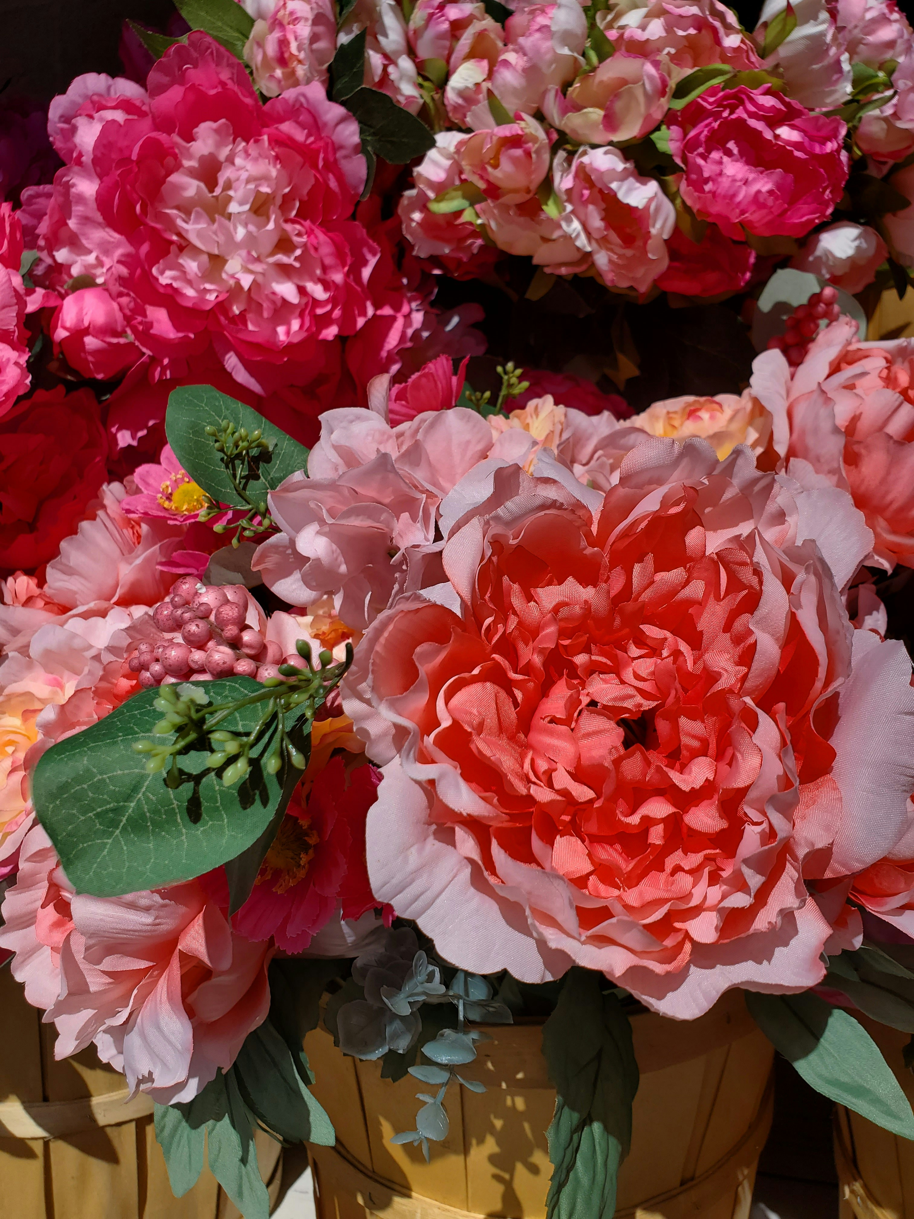 Vibrant coral and peach peonies in a lush garden-style arrangement