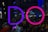Large illuminated letters spelling 'DO' stand prominently against a nighttime urban backdrop, surrounded by a crowd of people. The letter 'D' is illuminated in purple, while the 'O' is bright pink. City lights and reflections add to the vibrant atmosphere, with the crowd appearing lively and engaged.