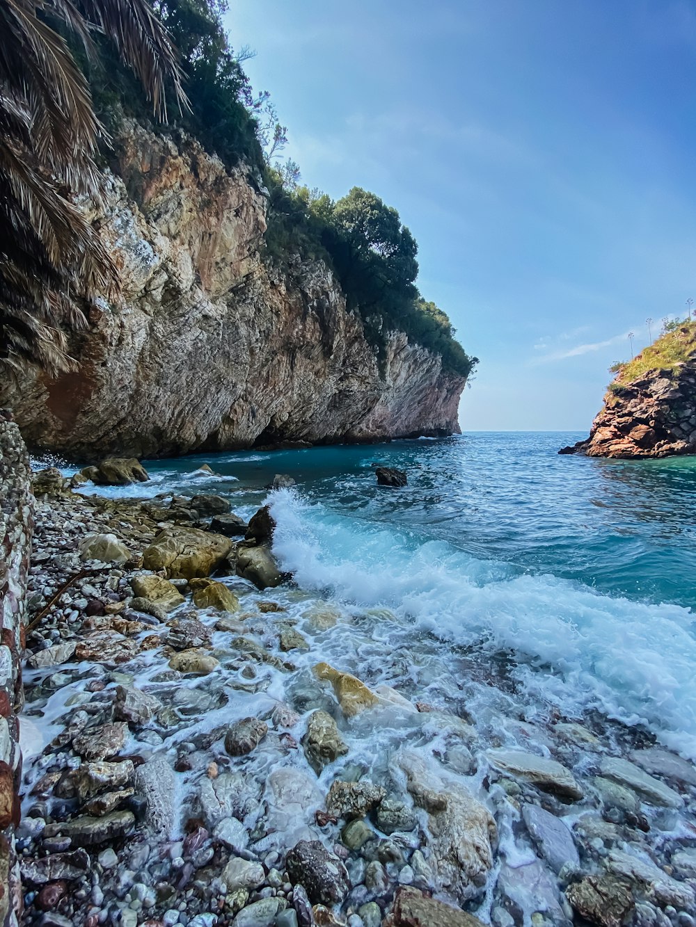 a rocky beach with waves crashing against the rocks