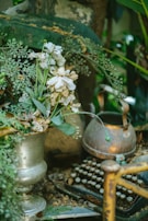 An old typewriter surrounded by nature, symbolizing creativity.