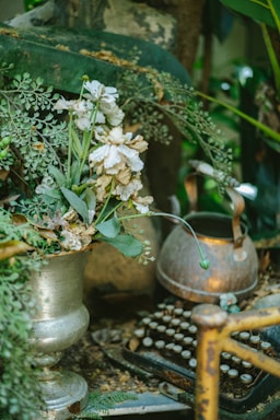 A cozy garden nook with a vintage typewriter and scattered story notes beneath a leafy hedge.