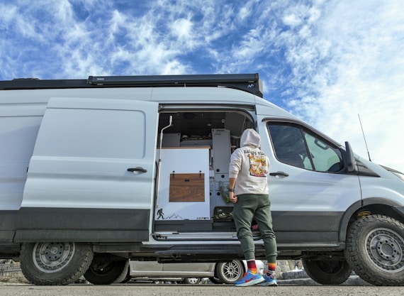 a man standing in the doorway of a van