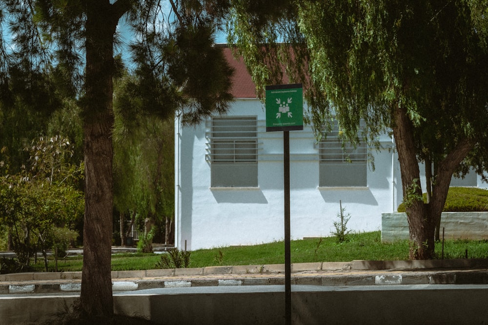 a street sign in front of a white building