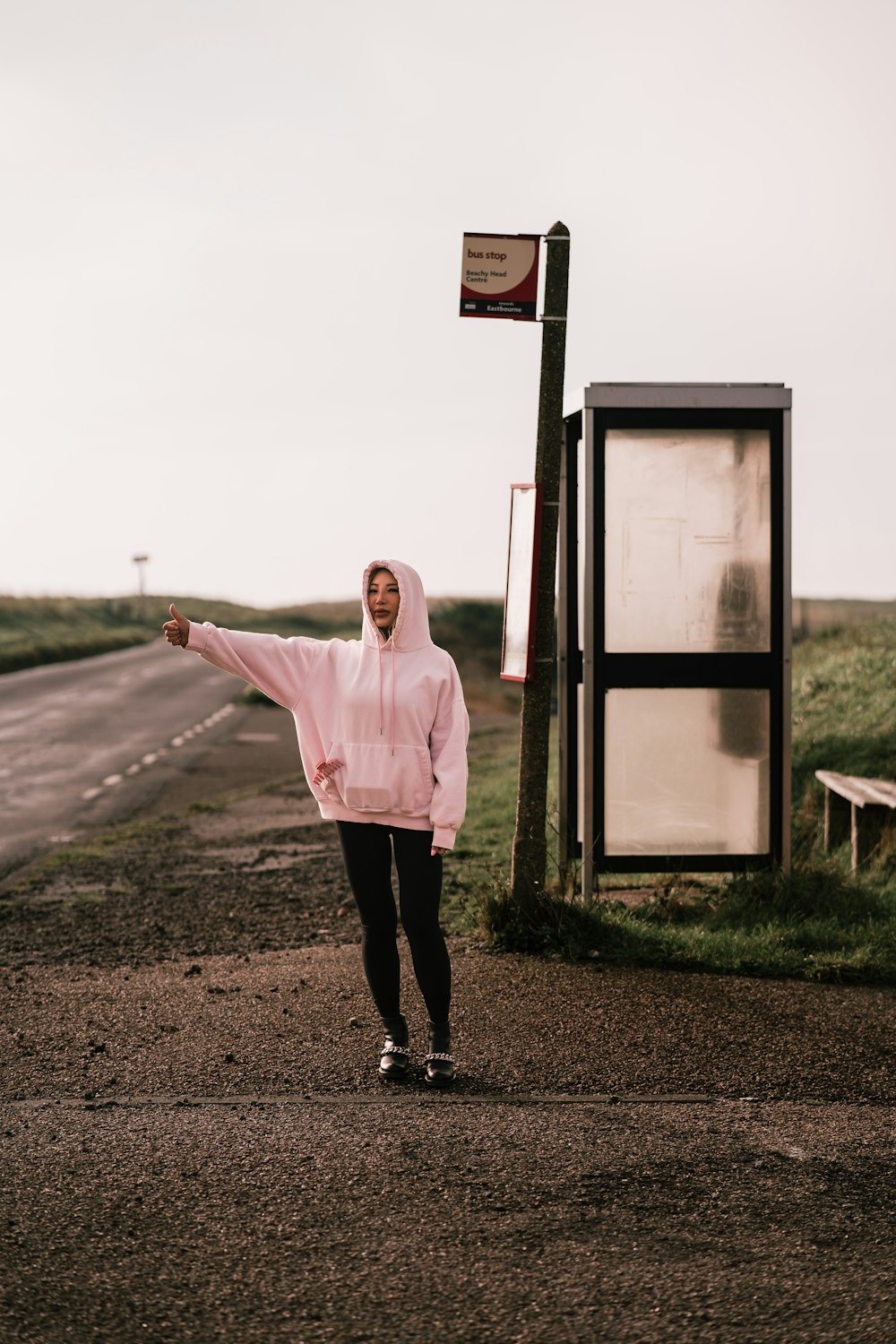 a man in a pink hoodie pointing at something