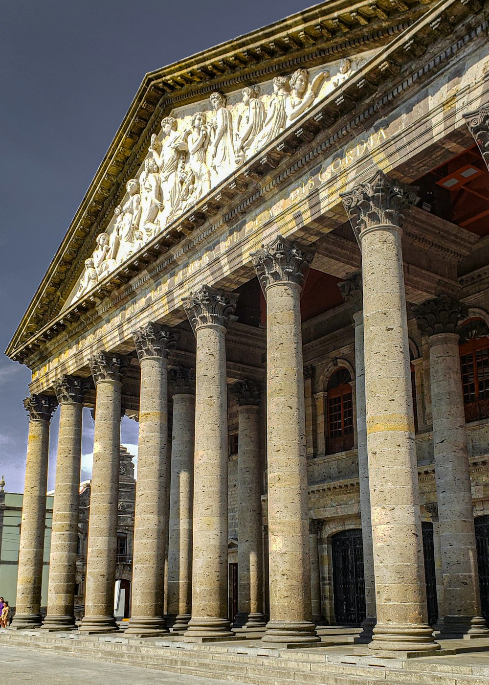 a large building with columns and statues on it
