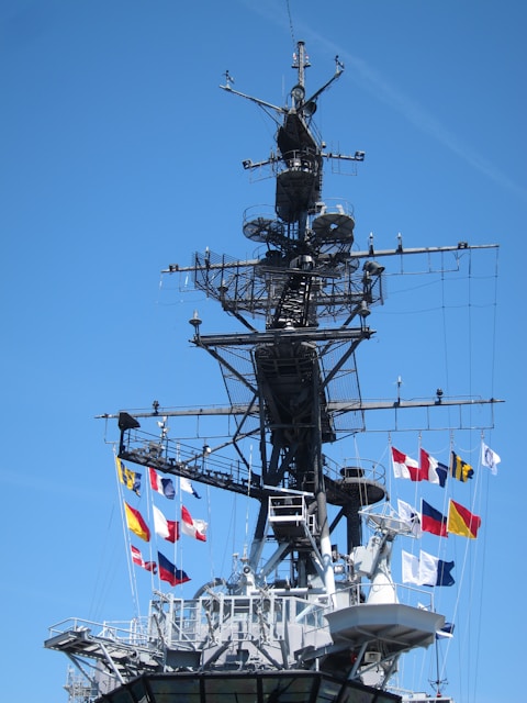 a large ship with a lot of flags on it