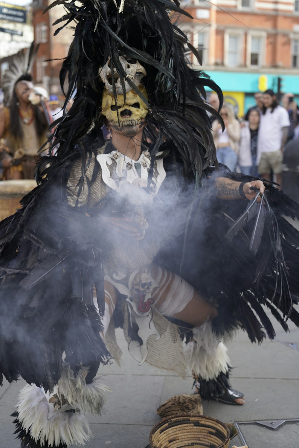 a man dressed in a costume with feathers and feathers on his head