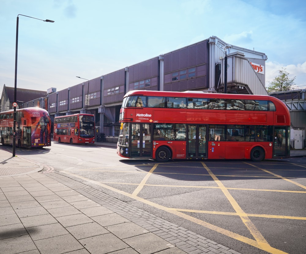 two red double decker buses parked next to each other