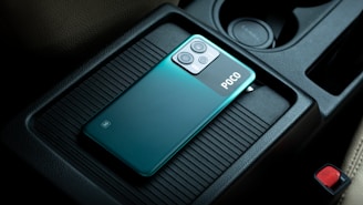a close up of a cell phone in a car