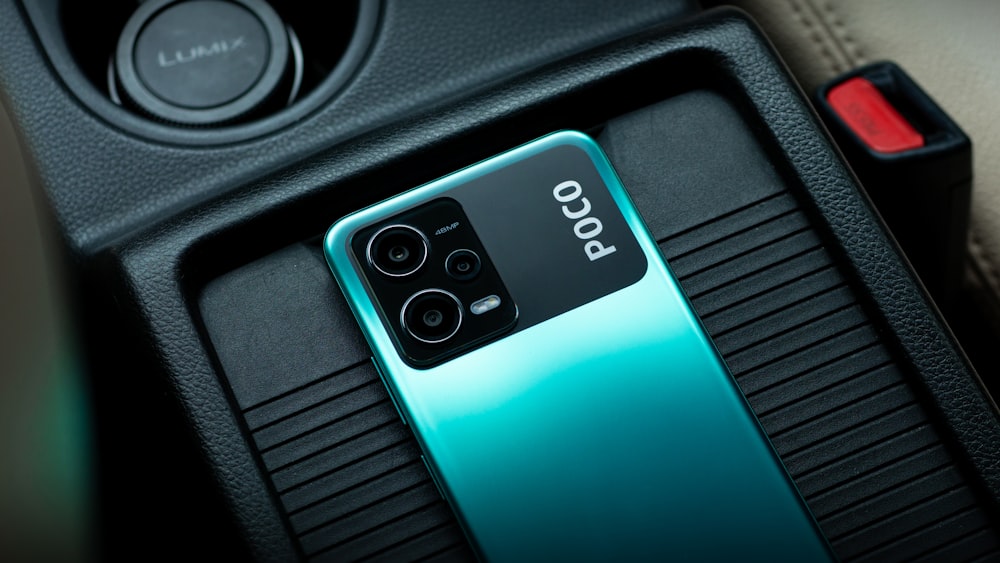 a close up of a cell phone in a car