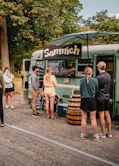 a group of people standing outside of a food truck