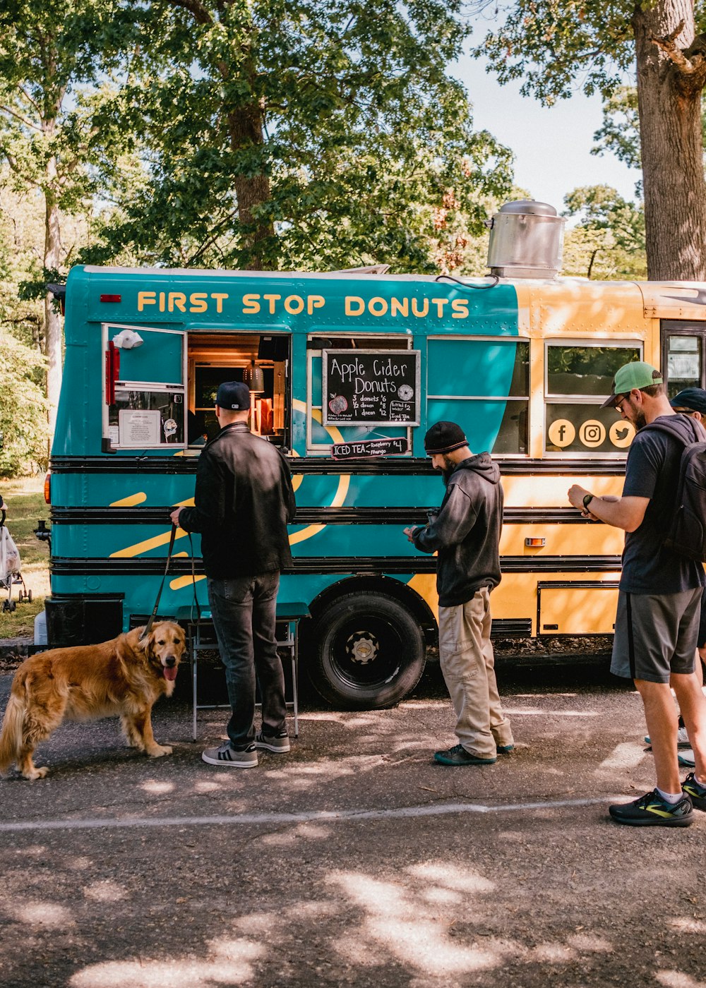 a group of people standing in front of a food truck