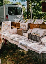 Colorful print-on-demand merchandise displayed on a wooden table.
