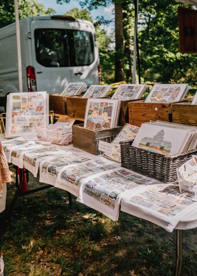 A vibrant display of colorful marketing materials spread out on a wooden table.