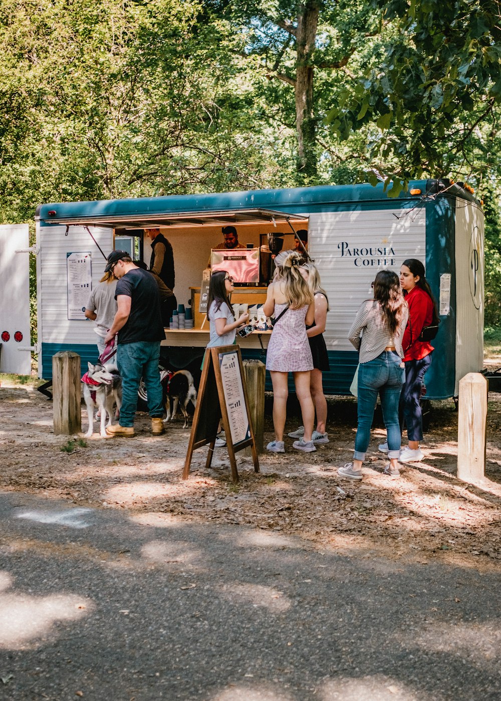 a group of people standing around a food truck