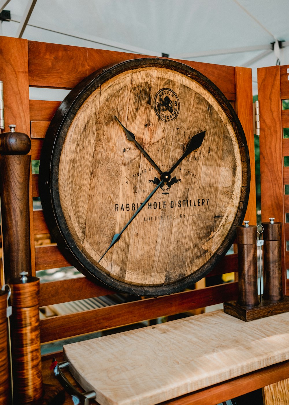 a clock made out of a wooden barrel