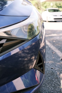 Front sensor installed on a vehicle bumper, highlighted by subtle electric blue accents.