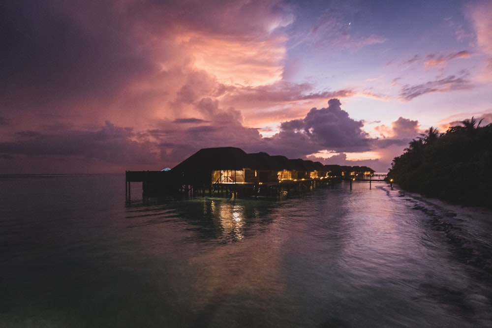 a sunset view of a resort on the water