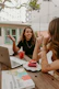 Two women sitting at a table with a laptop