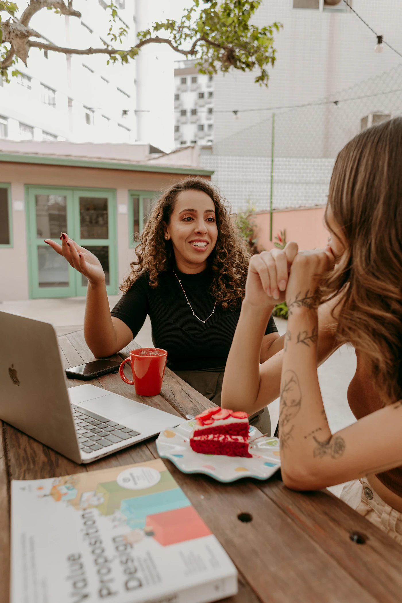 Two business owners having a friendly conversation beside a laptop