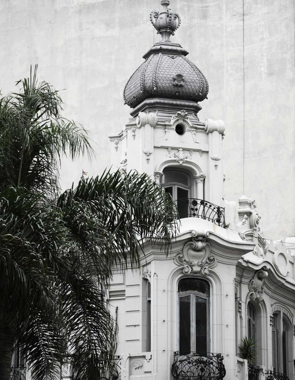 a large white building with a clock on the top of it